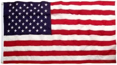 A tattered American flag with 50 stars and 13 stripes.
